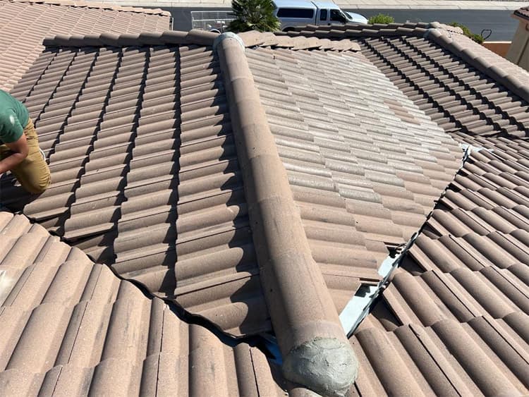 Roof repair warning signs Cracked tile roof being inspected on a Tucson home